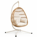 Sedia sospesa in rattan con cuscini crema e supporto in metallo